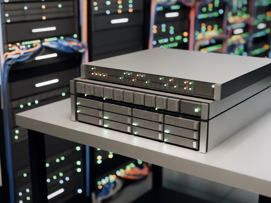 Three rack servers of different sizes stacked on a workbench